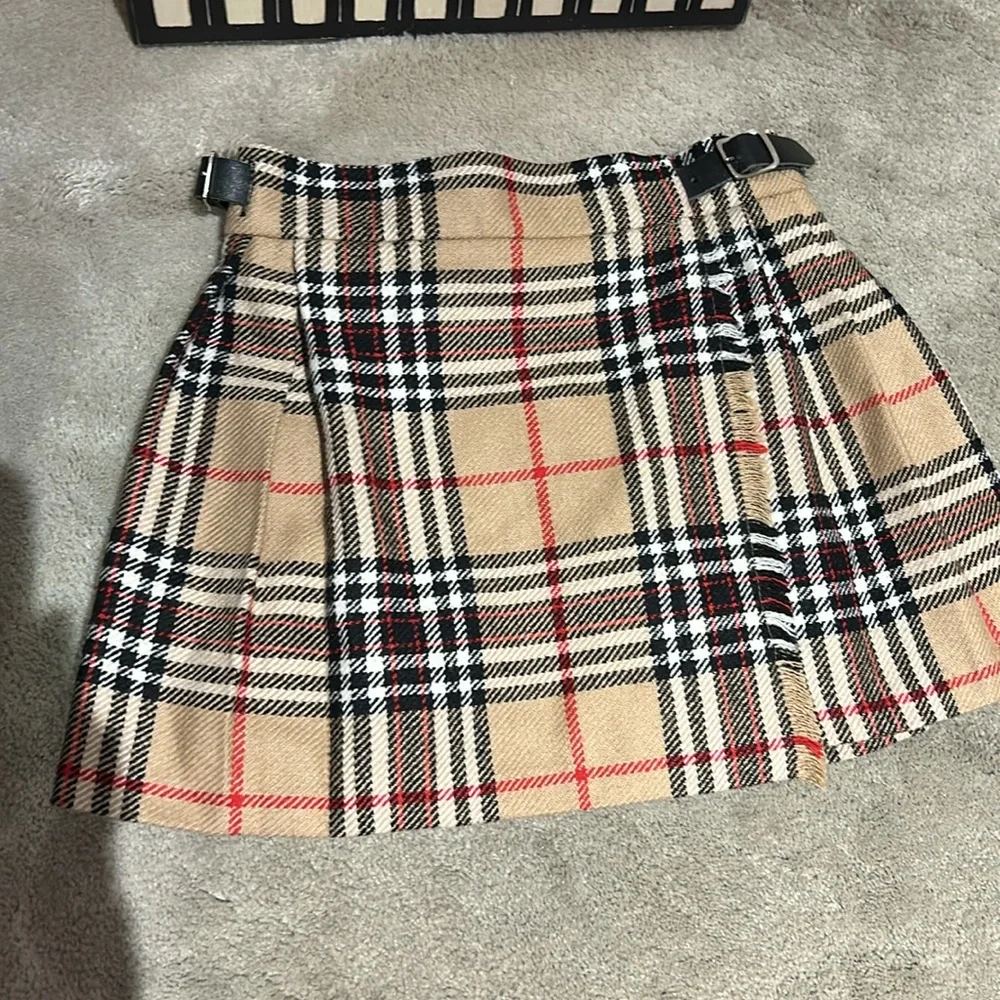 Toddler plaid skirt measures approximately 10 1/2 inches across the waist. - Picture 1 of 8
